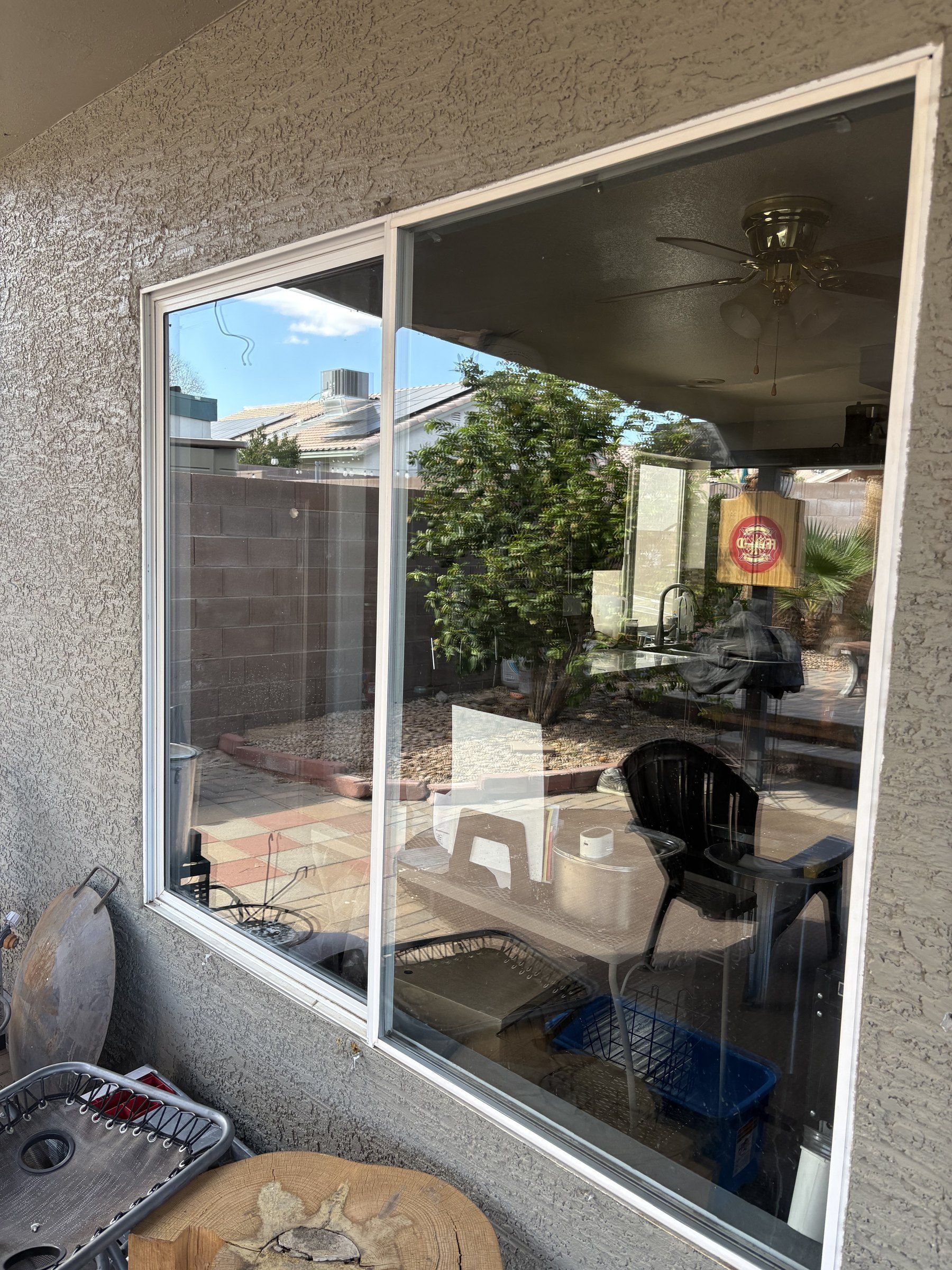 Cleaned living room window at a Las Vegas Valley home, with the covered patio visible through the glass