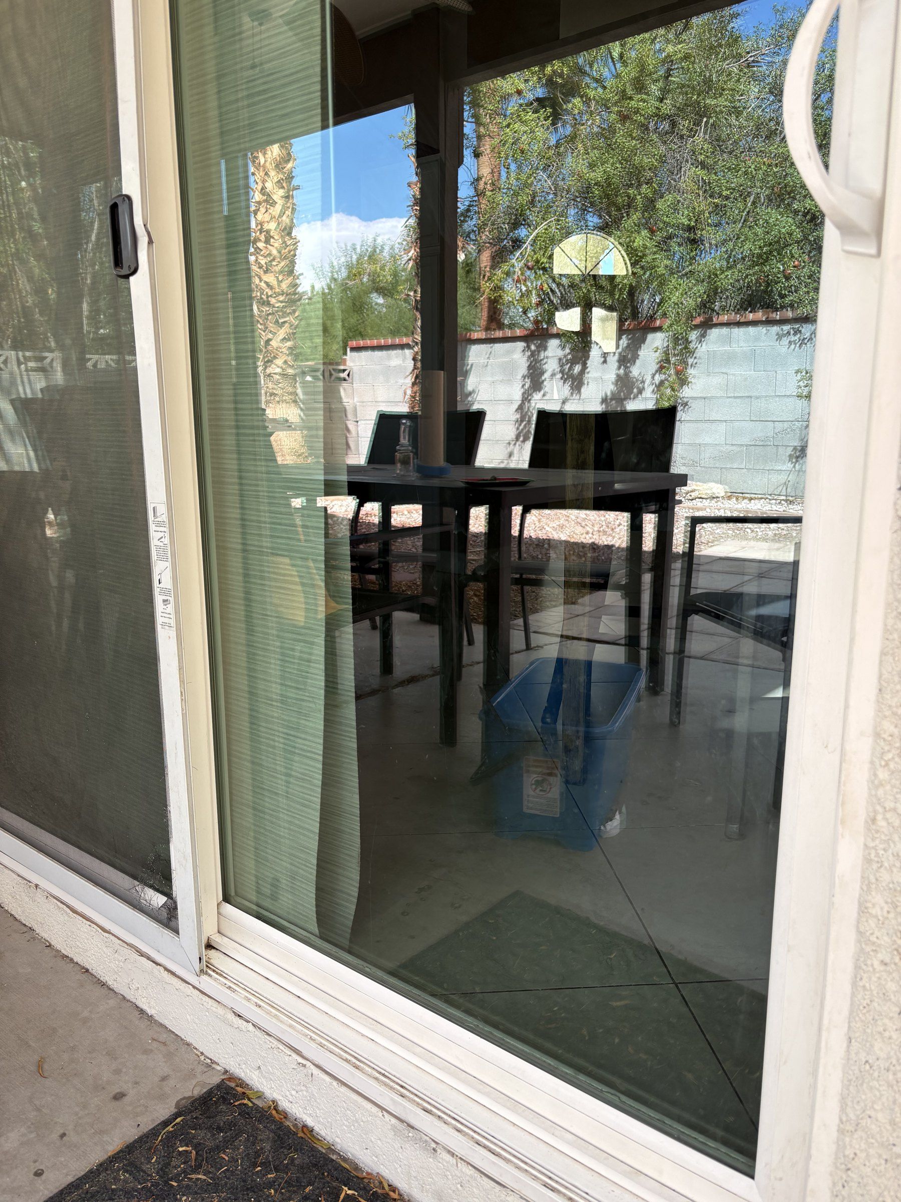 Cleaned sliding glass door at a Las Vegas Valley home, with the shaded patio and table seen through it